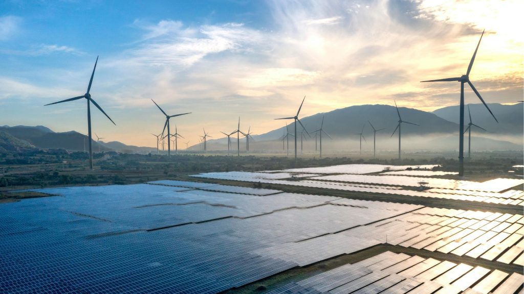 Aerial view of a solar PV farm and wind turbines representing wheeled energy generation in South Africa